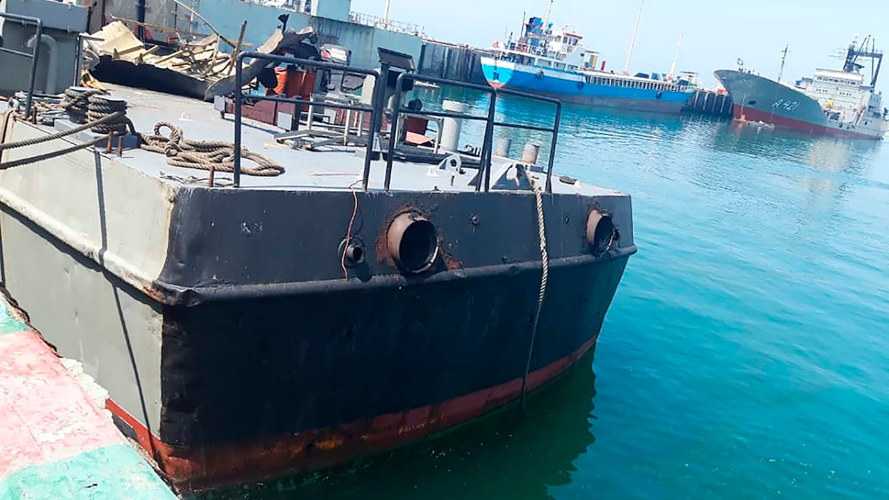 In this photo provided Monday, May 11, 2020, by the Iranian Army, the Konarak support vessel which was struck during a training exercise in the Gulf of Oman, is docked in an unidentified naval base in Iran.mage caption