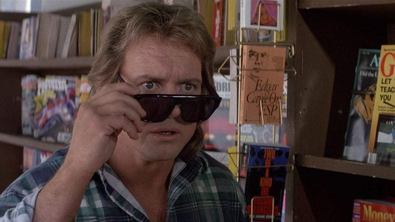“Nada” (Roddy Piper) finds the infamous sunglasses that expose the truth.