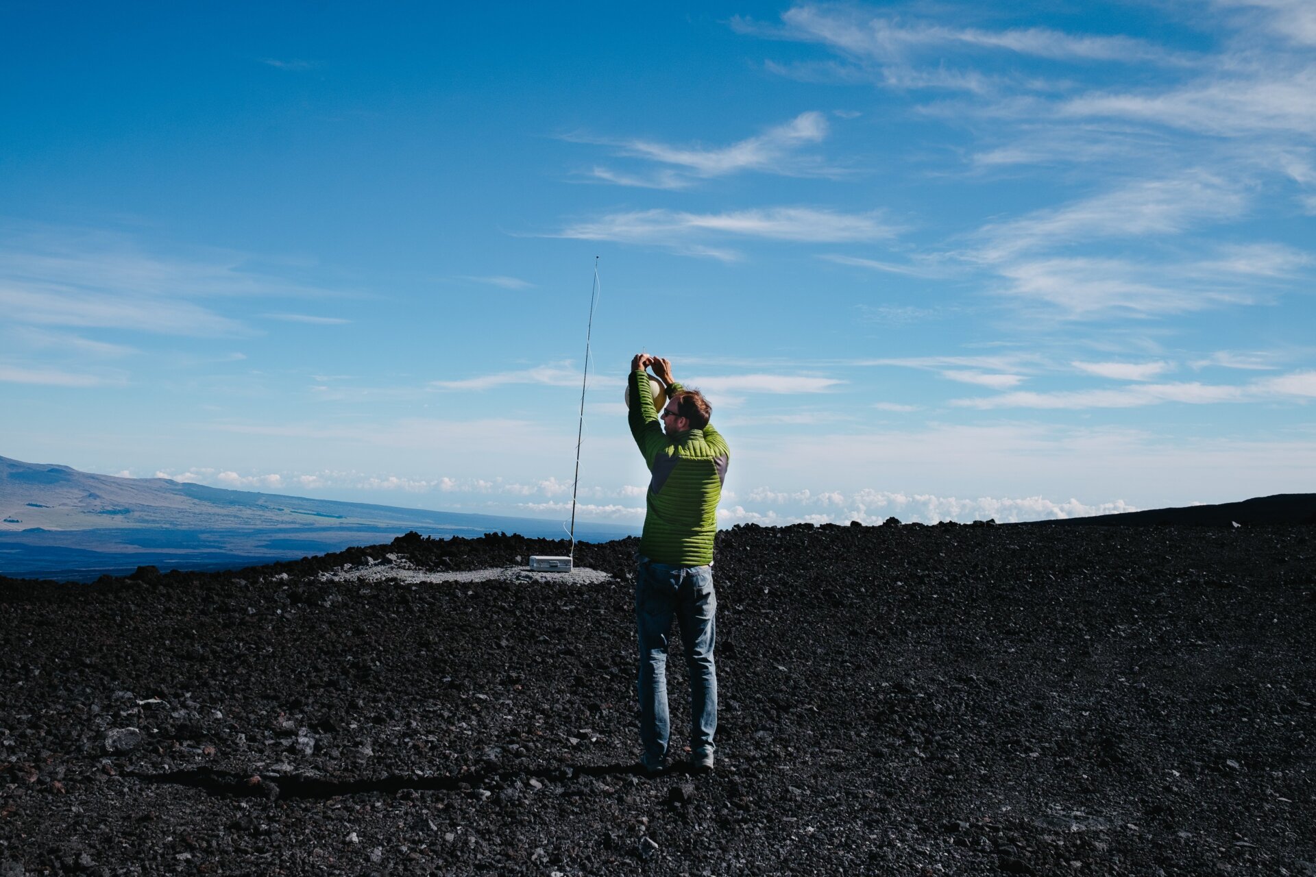 Aidan Colton holds his breath as he takes one of two Keeling Curve samples for the day. The day’s NOAA sampling equipment is visible in the background.