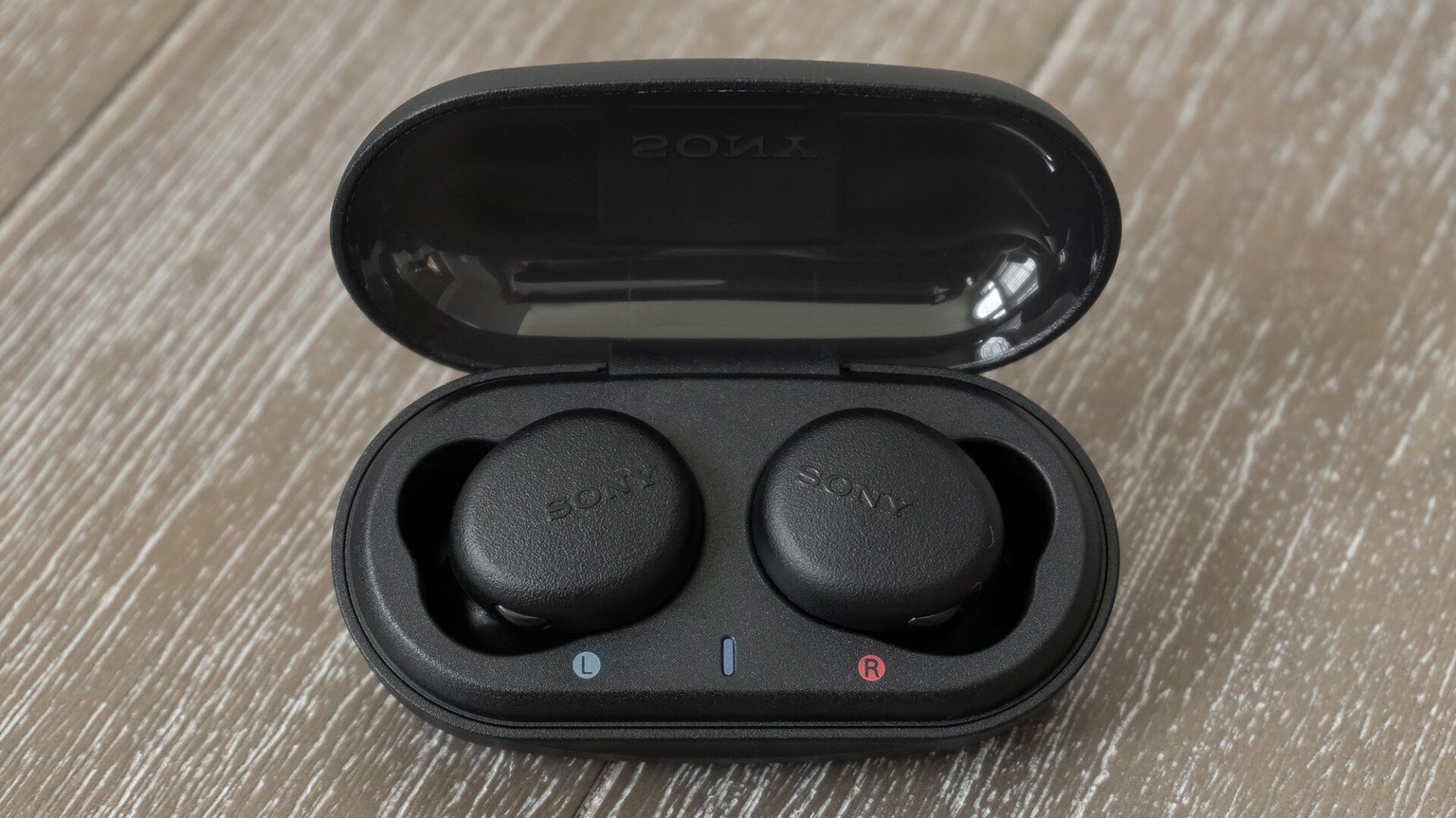 The WF-XB700s’ charging case feels cheap, but its flat bottom design means it can be placed on a desk while still providing easy access to the earbuds.
