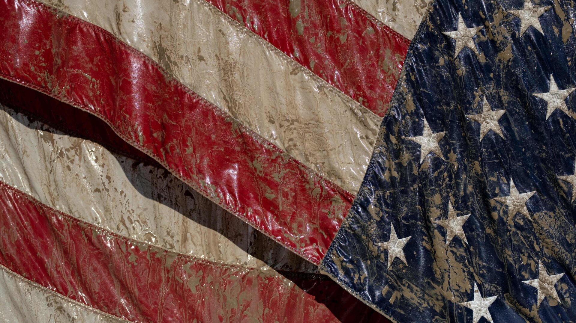Just as floodwaters brought down this flag in Sanford, Michigan, Donald Trump will bring down the nation’s infrastructure with his deregulatory agenda.