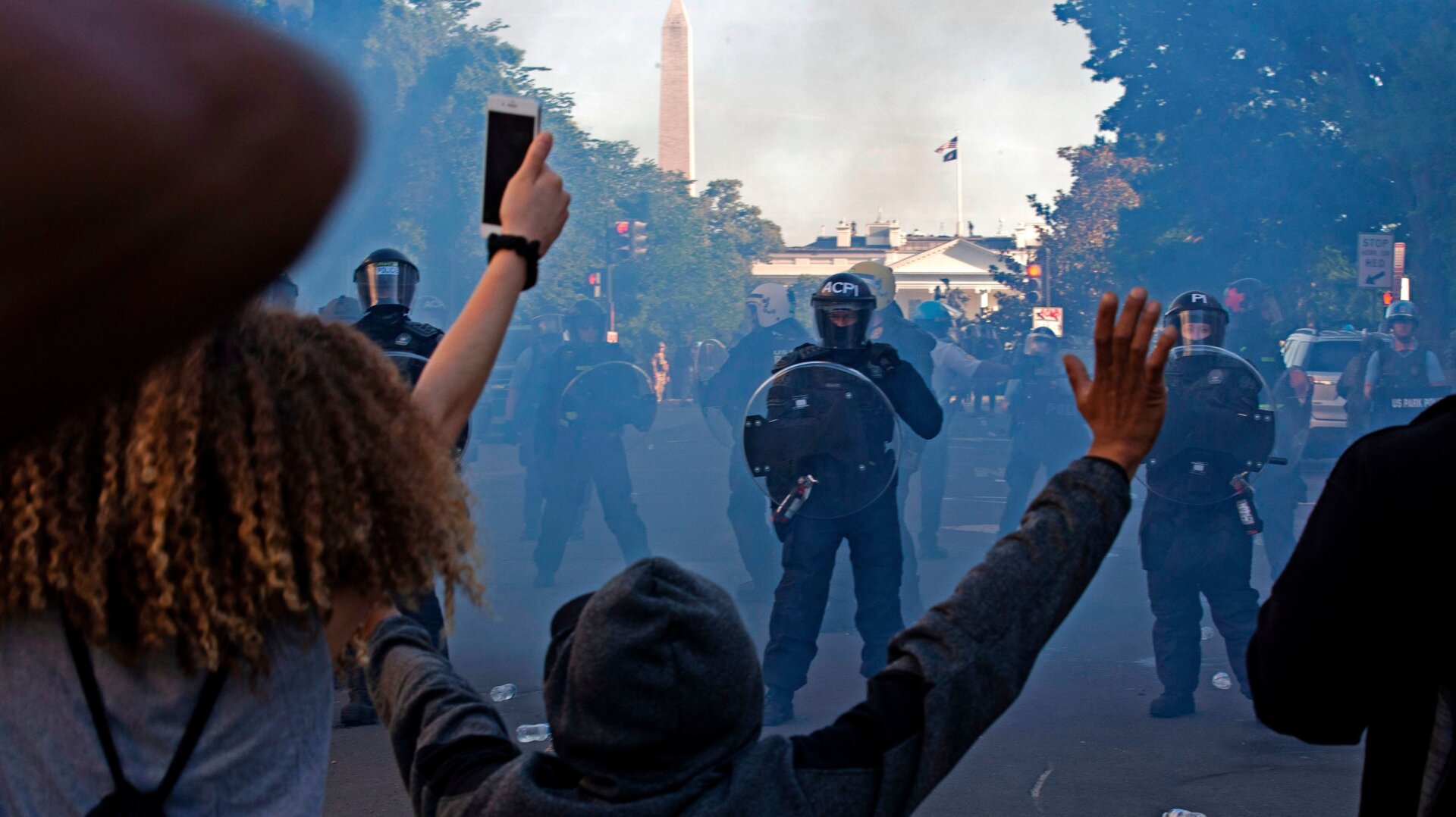 Riot police use tear gas to push back protesters outside the White House on June 1, 2020.