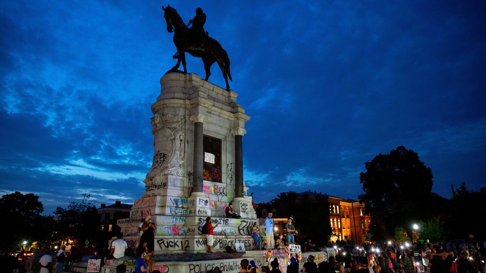 People gather around the Robert E. Lee statue in Richmond, Virginia, on June 4, 2020, amid continued protests over the police killing of George Floyd.