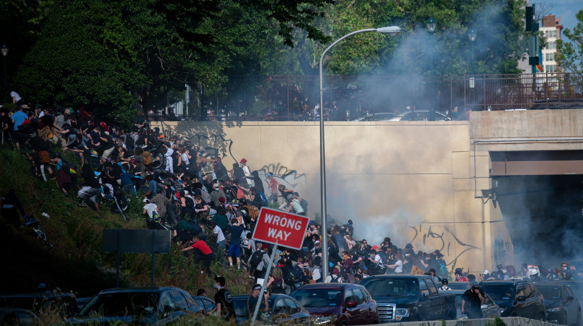 Protesters scramble in Center City, Philadelphia after police launched tear gas at them near a tunnel exit.