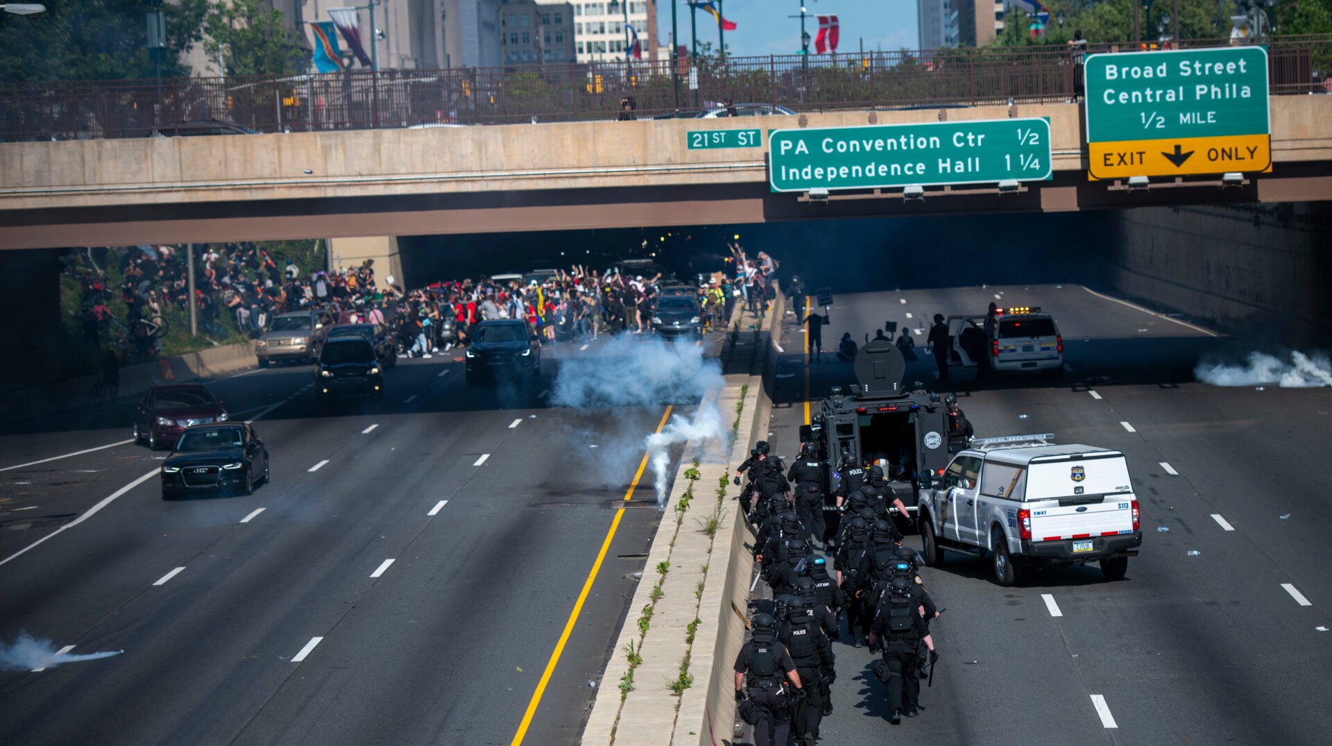 Protesters scramble in Center City, Philadelphia after police launched tear gas at them near a tunnel exit.