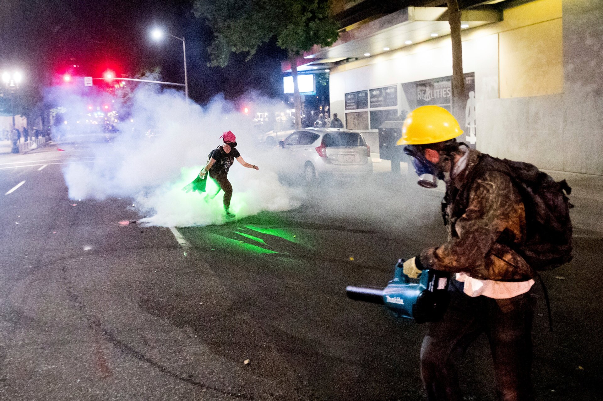 Protesters hold leaf blowers to extinguish tear gas if deployed on the sixth night of action against police brutality in Portland, Ore., on June 4, 2020, after the death of George Floyd in police custody.