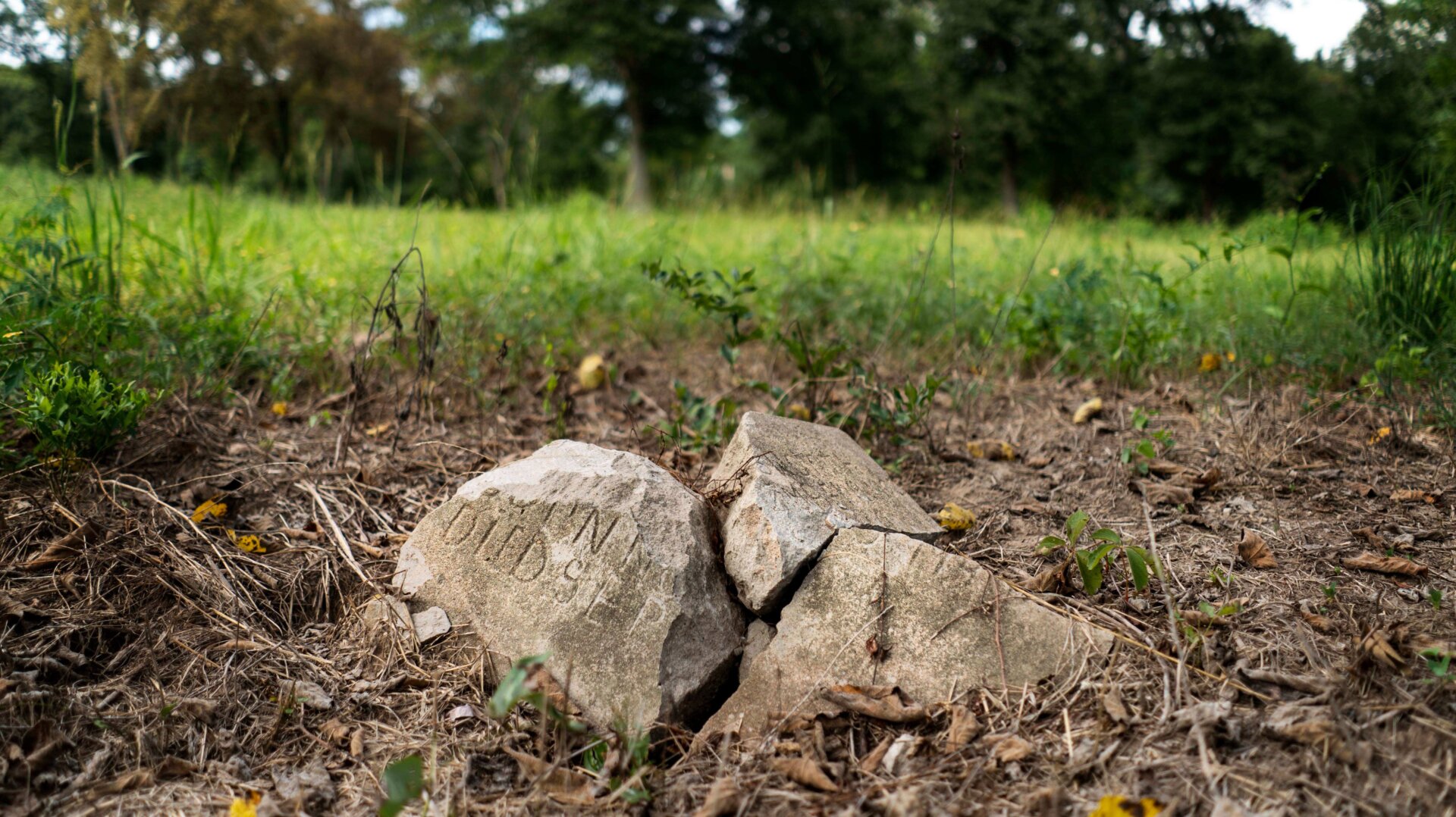 A broken gravestone lies in pieces in a slave graveyard on the Prairie View A&M University campus, a public historically black university, in Prairie View, Texas.