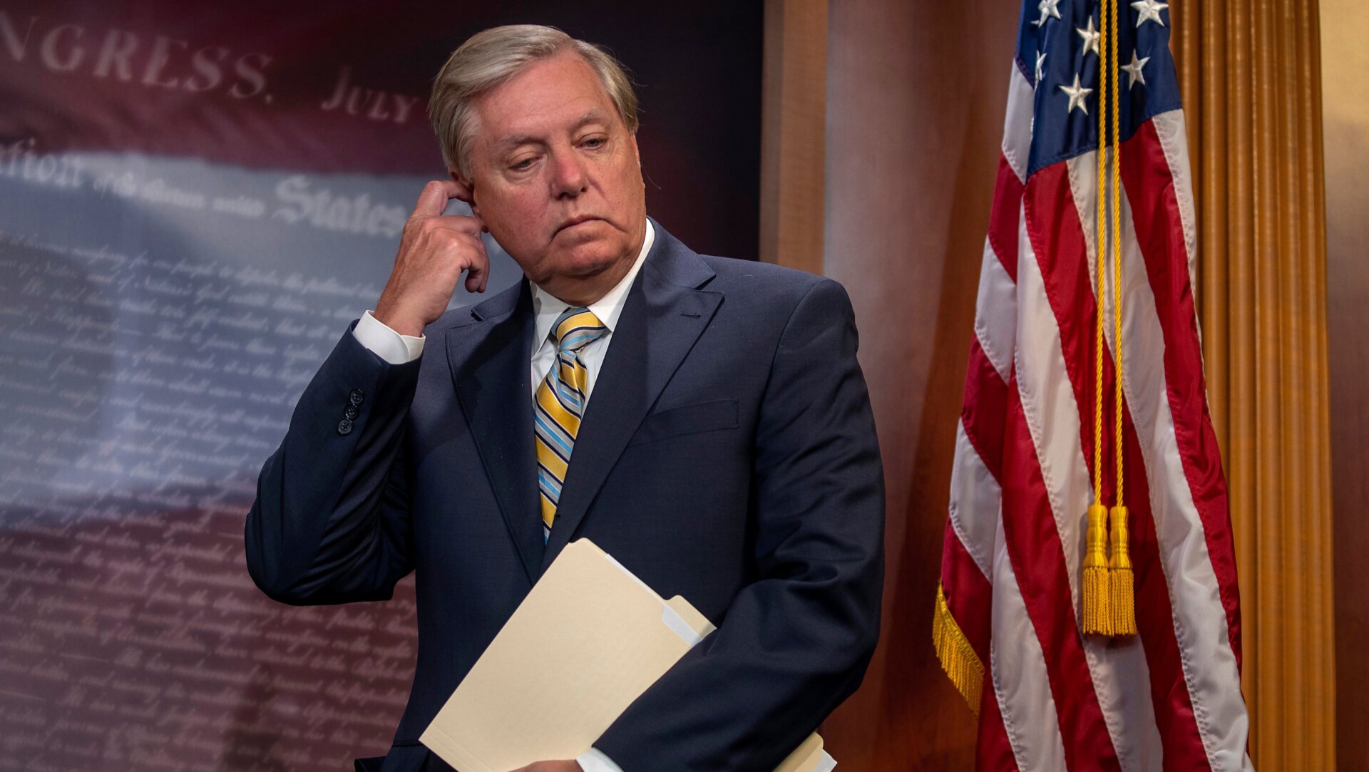 Sen. Lindsey Graham (R-SC) holding a manila folder and scratching his head on Capitol Hill July 01, 2020 in Washington, DC.