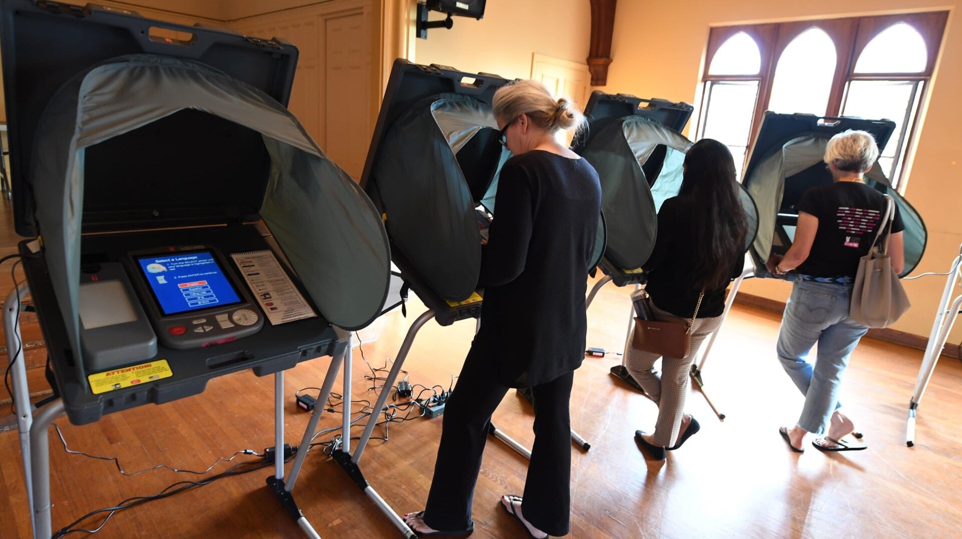 People use electronic voting machines to cast their ballot in the midterm elections at Neighborhood Congregational Church in Laguna Beach, California on election day in 2018.