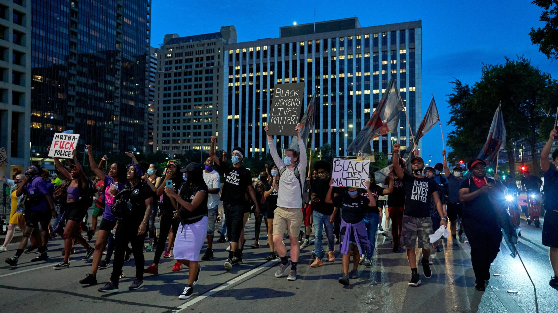 Protesters march down the streets during a rally in remembrance of Sandra Bland on July 13, 2020, in Dallas, Texas. e caption