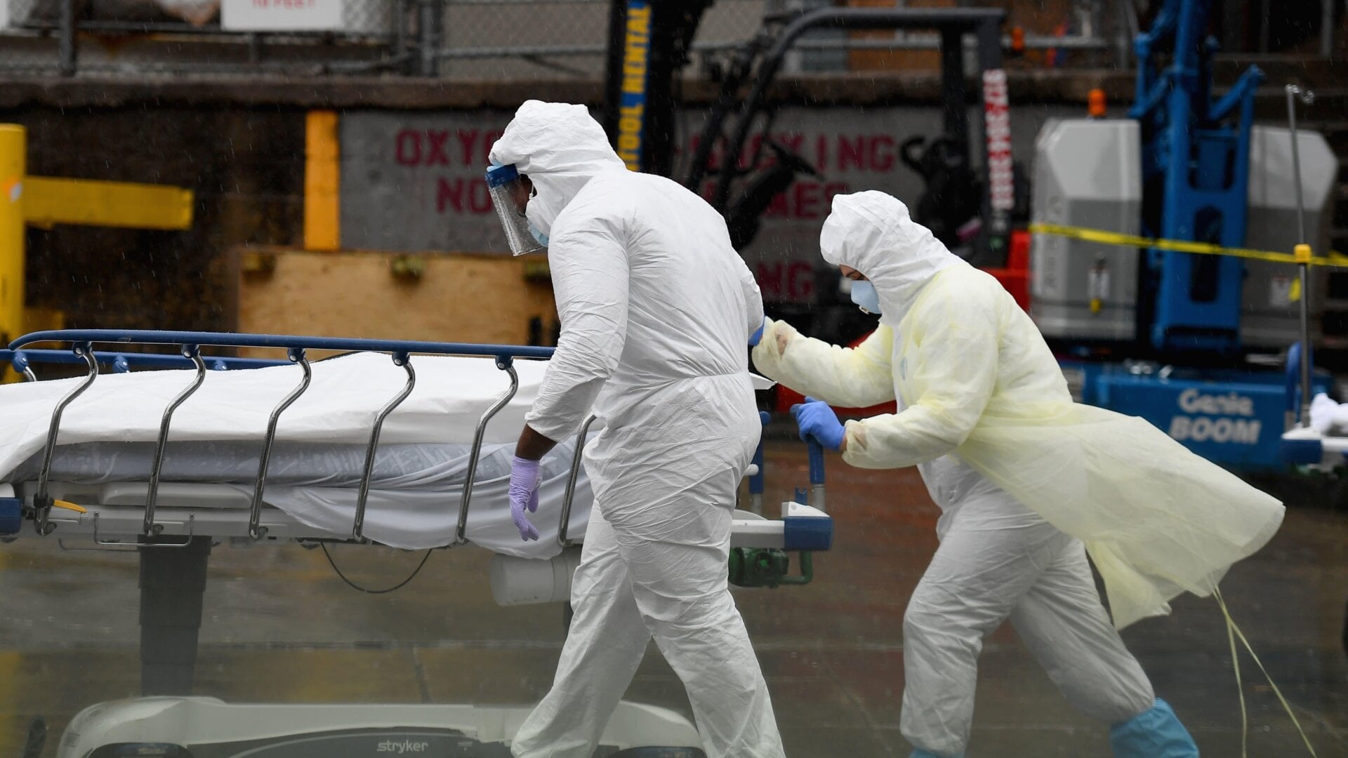 Health care workers in Brooklyn transporting a deceased patient who died of covid-19 to a refrigeration truck for temporary storage in early April.