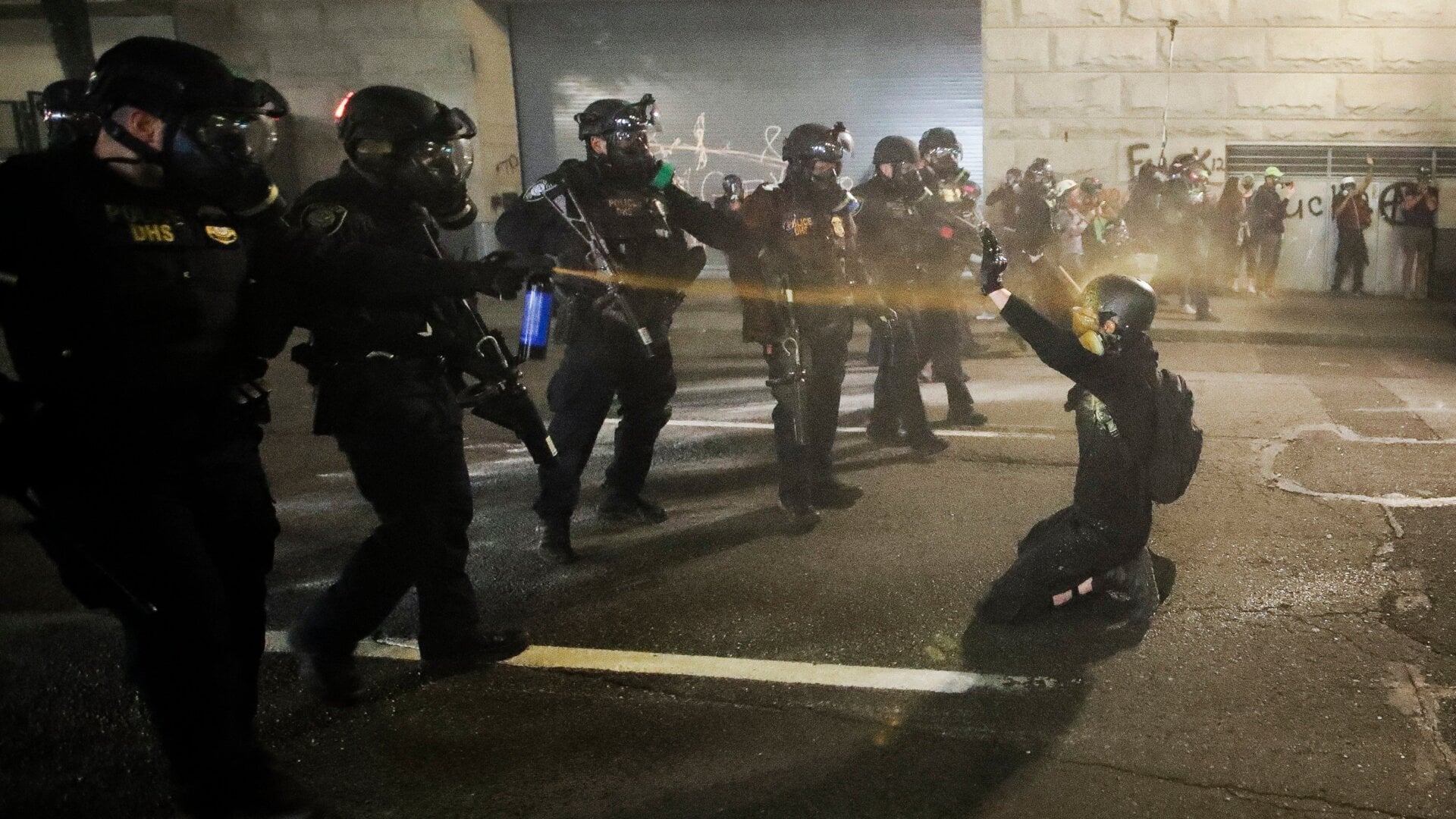 A demonstrator is pepper sprayed by DHS troops before being arrested on July 29, 2020, in Portland, Oregon.