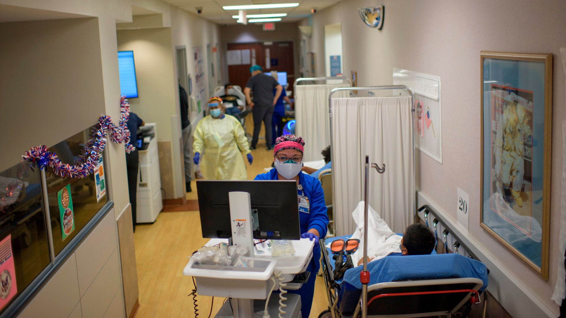A healthcare worker talks to a patient in the ER at the Oakbend Medical Center in Richmond, Texas, on July 15, 2020.
