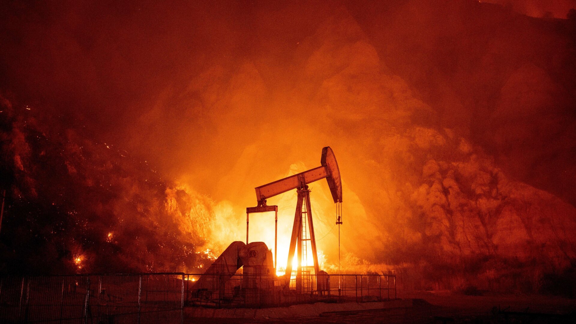 Flames from the Maria fire burn through an oil field in Santa Paula, California late on October 31, 2019.