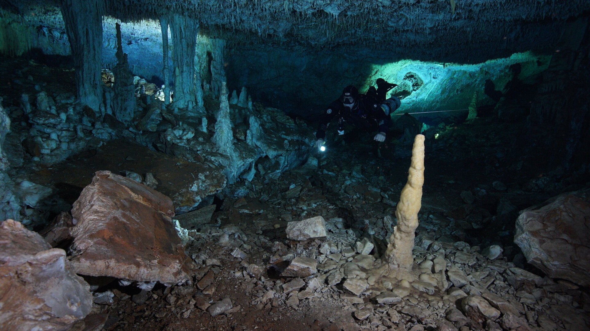 A diver exploring the submerged cave.