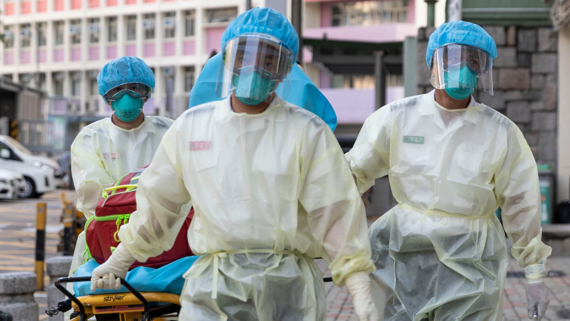 Medical staff wearing personal protective equipment as a precautionary measure against the COVID-19 coronavirus while entering the Lei Muk Shue care home in Hong Kong on August 23, 2020.