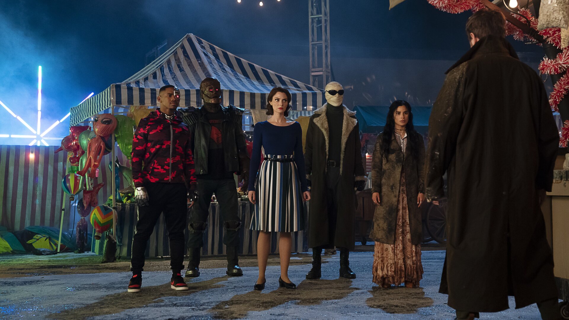The Doom Patrol arriving at a carnival to fight the Candlemaker.