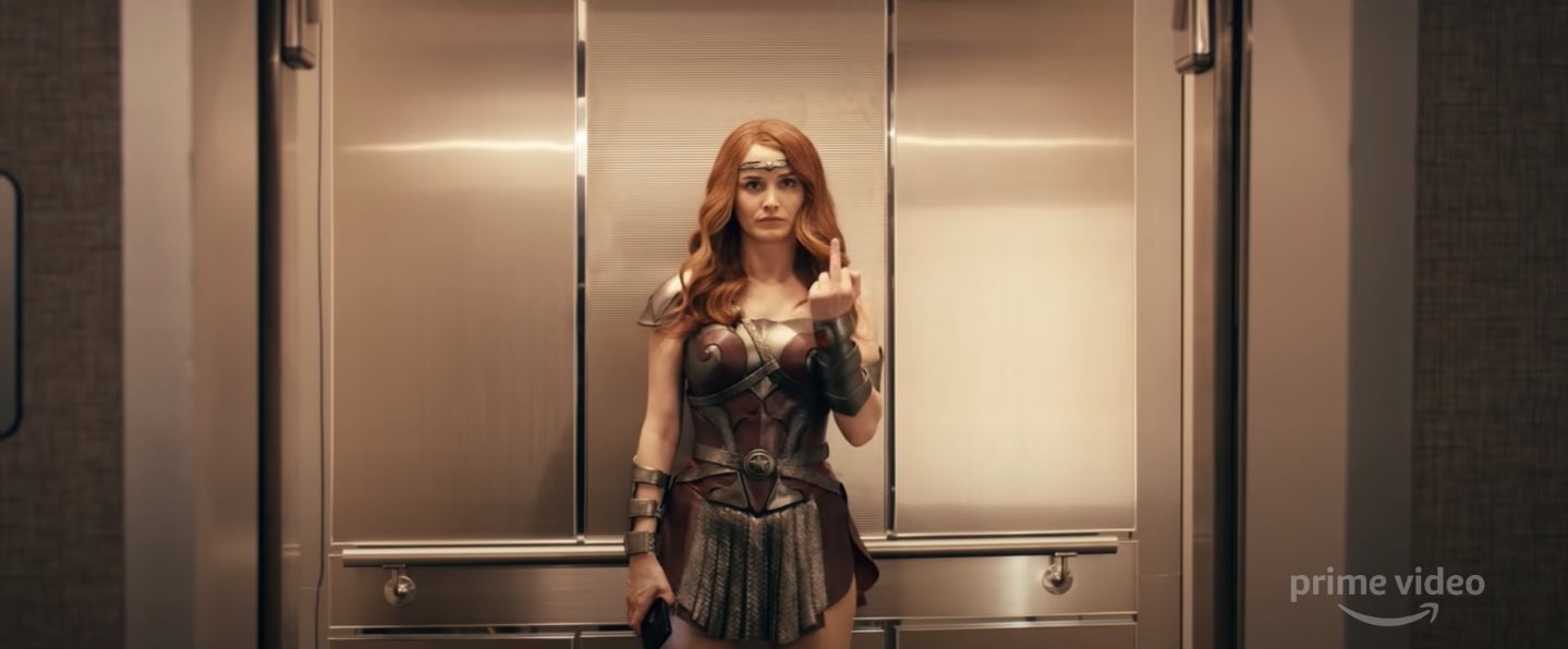 Queen Maeve giving one of her handlers the finger.