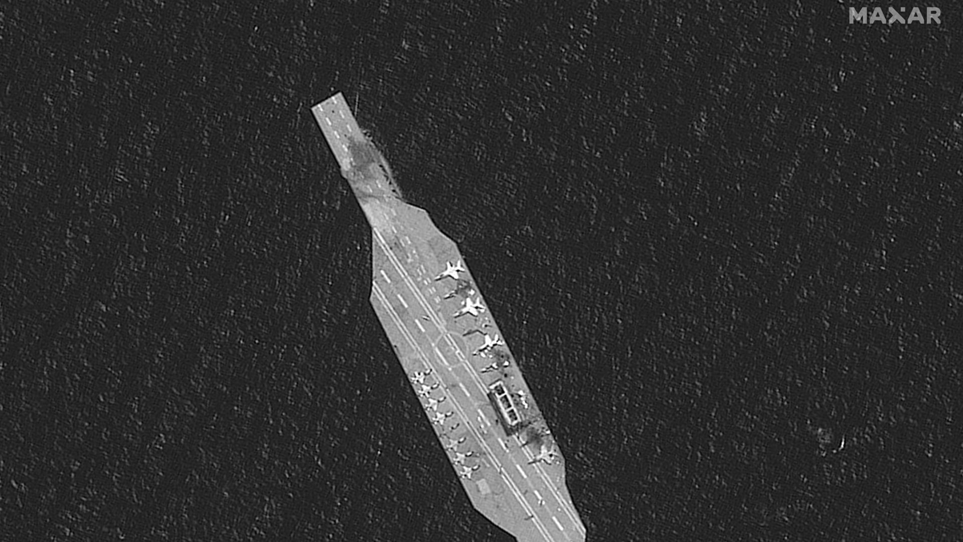 A satellite photo of an Iranian mock-up aircraft carrier damaged by IRGC live-fire exercises in the Strait of Hormuz on July 28, via Maxar Technologies.
