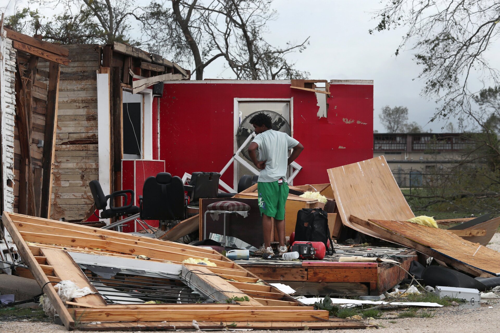 James Sonya surveys what is left of his uncle’s barber shop after Hurricane Laura passed through the area on August 27, 2020 in Lake Charles, Louisiana.
