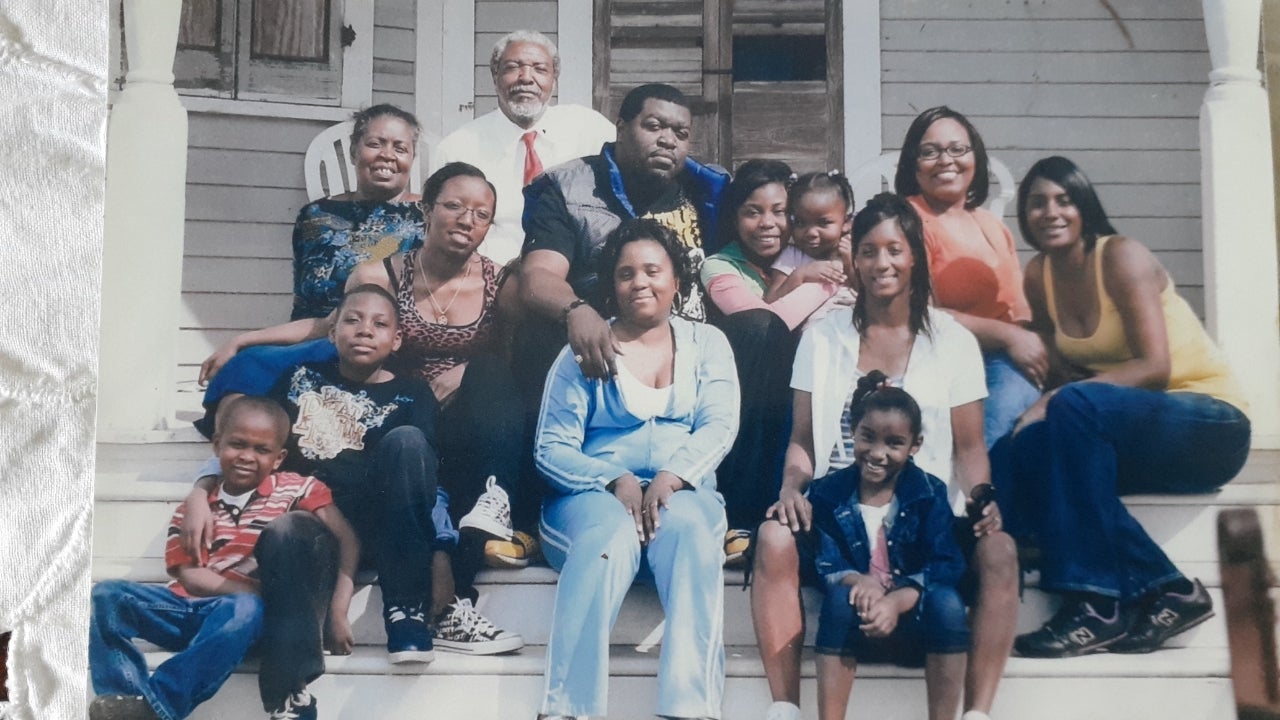 Calvin Alexander is joined on his porch by his wife, children, and most of his grandchildren shortly after Hurricane Katrina hit in 2005.
