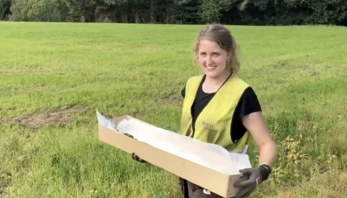 Astrid Kviseth carrying the sword away from the site. 