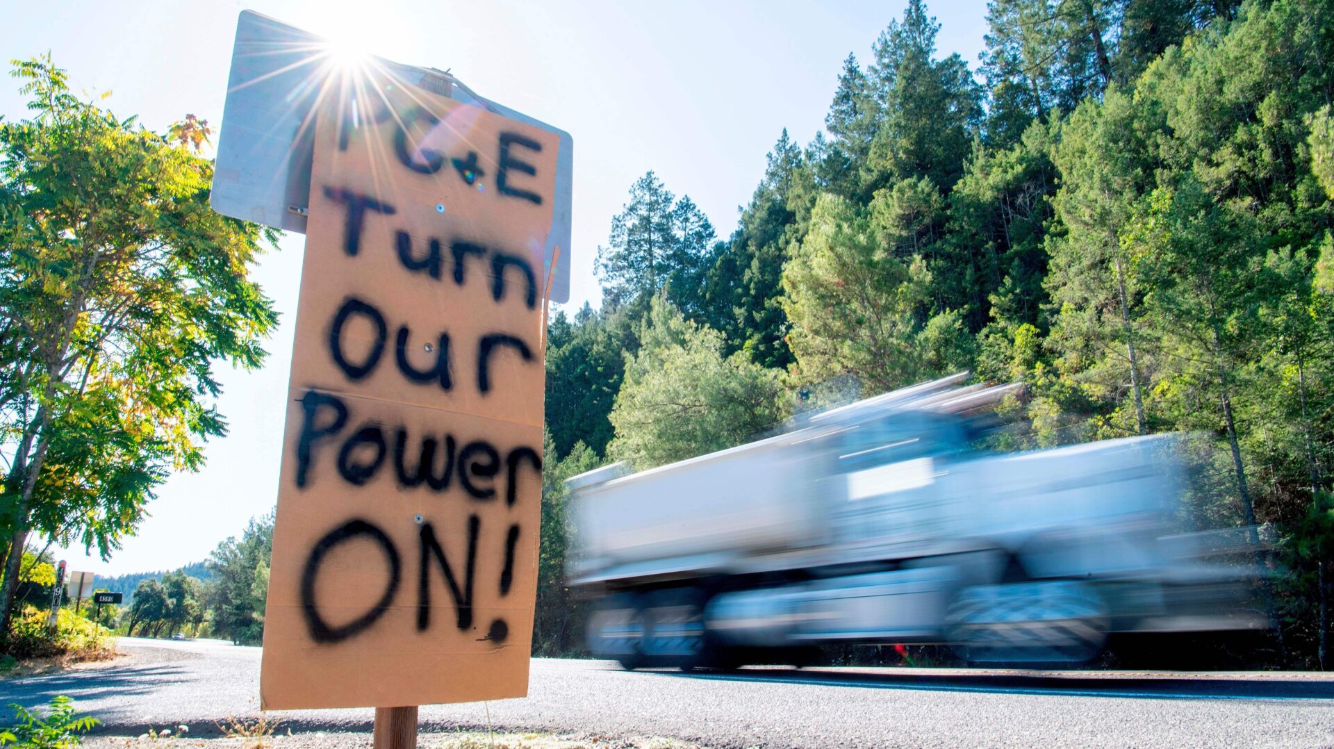 A sign calling for PG&E to turn the power back on is seen on the side of the road during a statewide blackout in Calistoga, California, on October, 10, 2019.