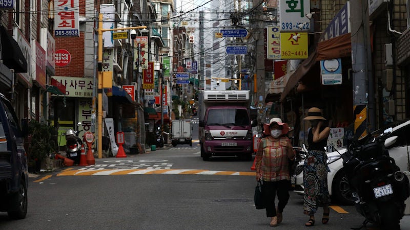 Pedestrians wear masks amid the coronavirus pandemic on August 26, 2020 in Seoul, South Korea.