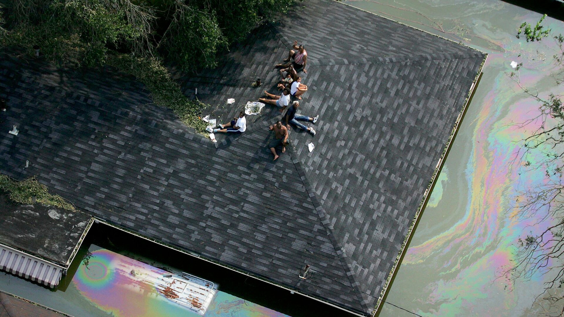 People stranded on a roof in New Orleans by Hurricane Katrina's floodwaters 15 years ago today.