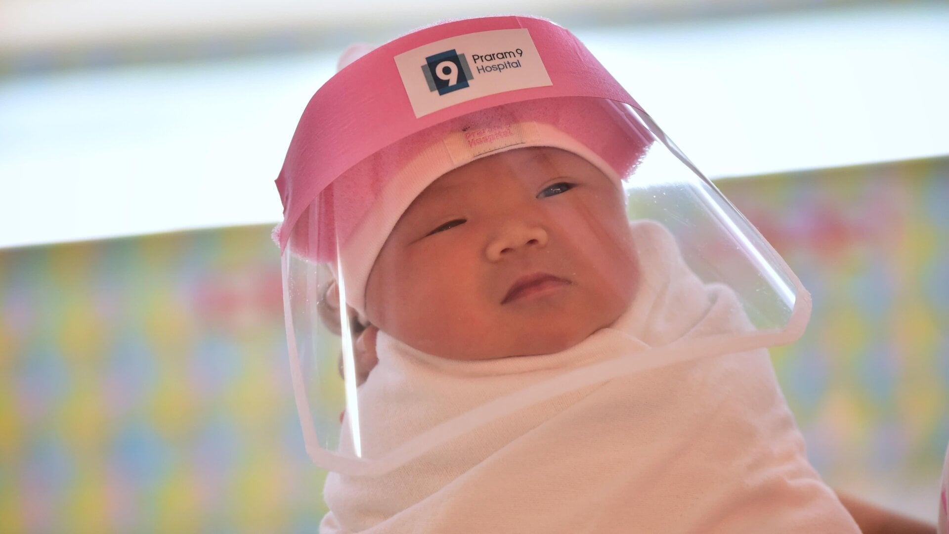 A photo of a newborn baby wearing a face shield, delivered at Praram 9 Hospital in Bangkok, Thailand on April 9, 2020.