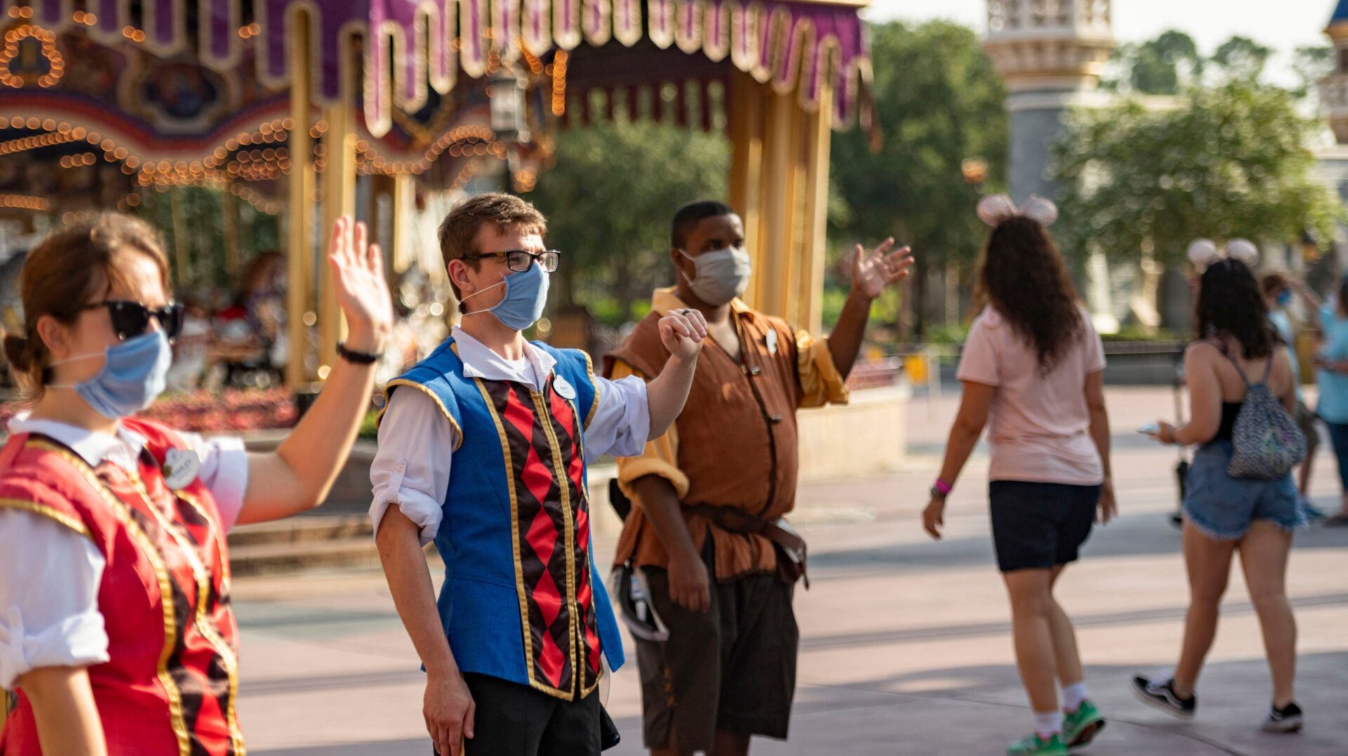 Masked Disney World employees welcoming guests back to the park on July 11.