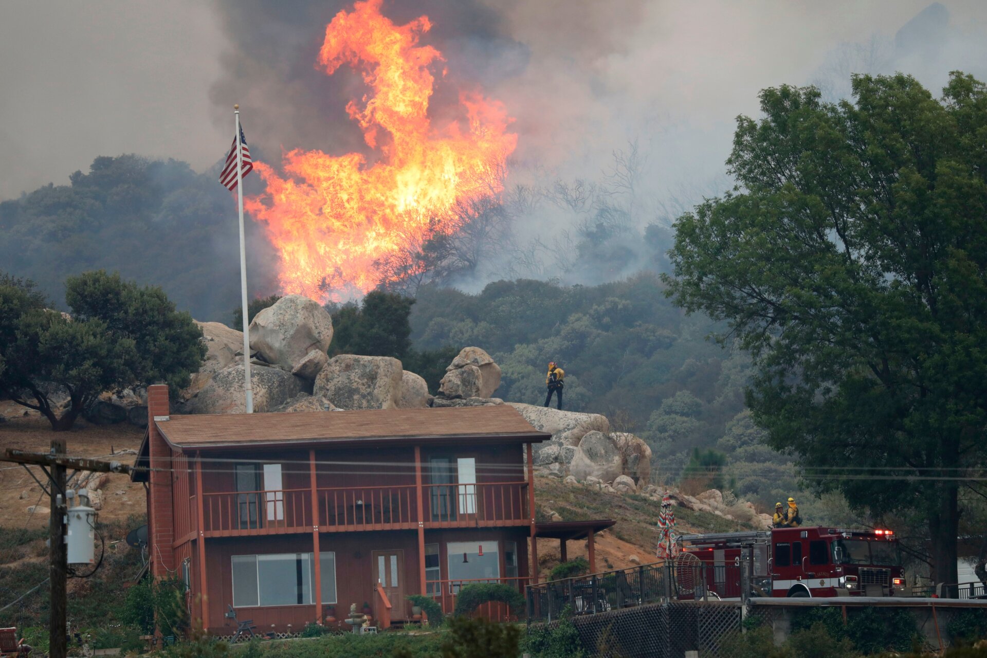 A brush fire encroaches along Japatul Road during the Valley Fire in Jamul, California, on Sept. 6, 2020.