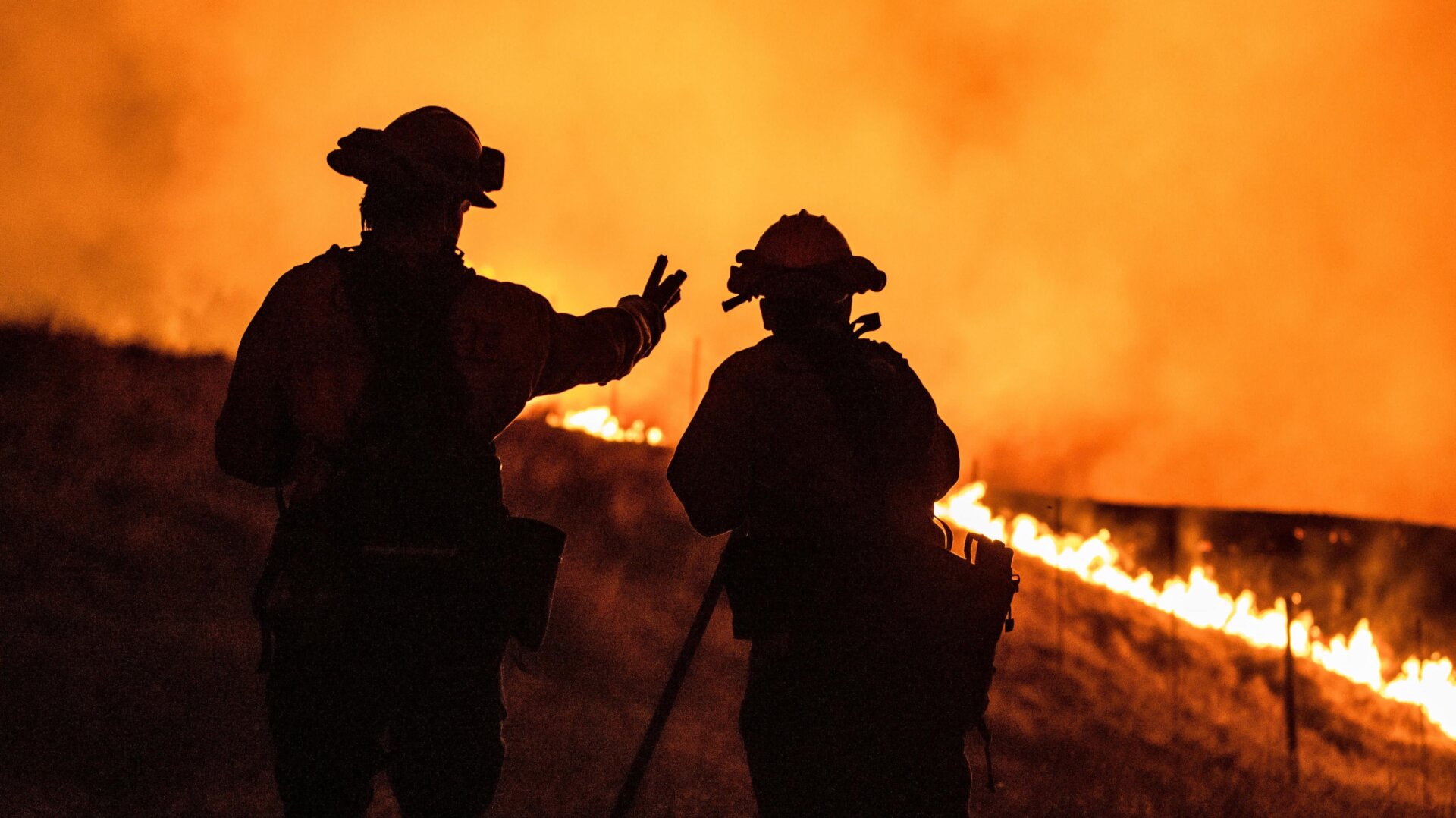 Fire fighters keep watching an approaching fire line on the outskirts of Santa Rosa, on September 27, 2020.