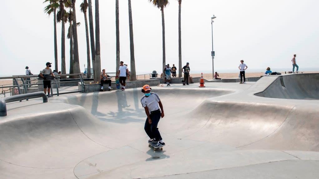 A man wearing a face mask skateboards at a skate park in Venice Beach, California, on September 15, 2020.