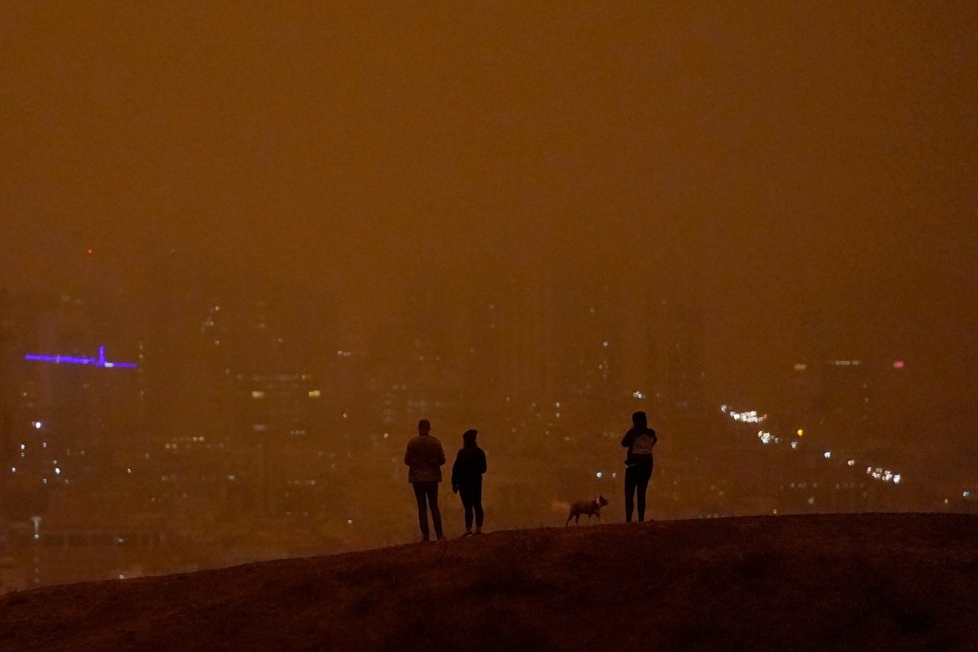 People look toward the skyline obscured by wildfire smoke in daytime from Kite Hill Open Space in San Francisco, Wednesday, Sept. 9, 2020.