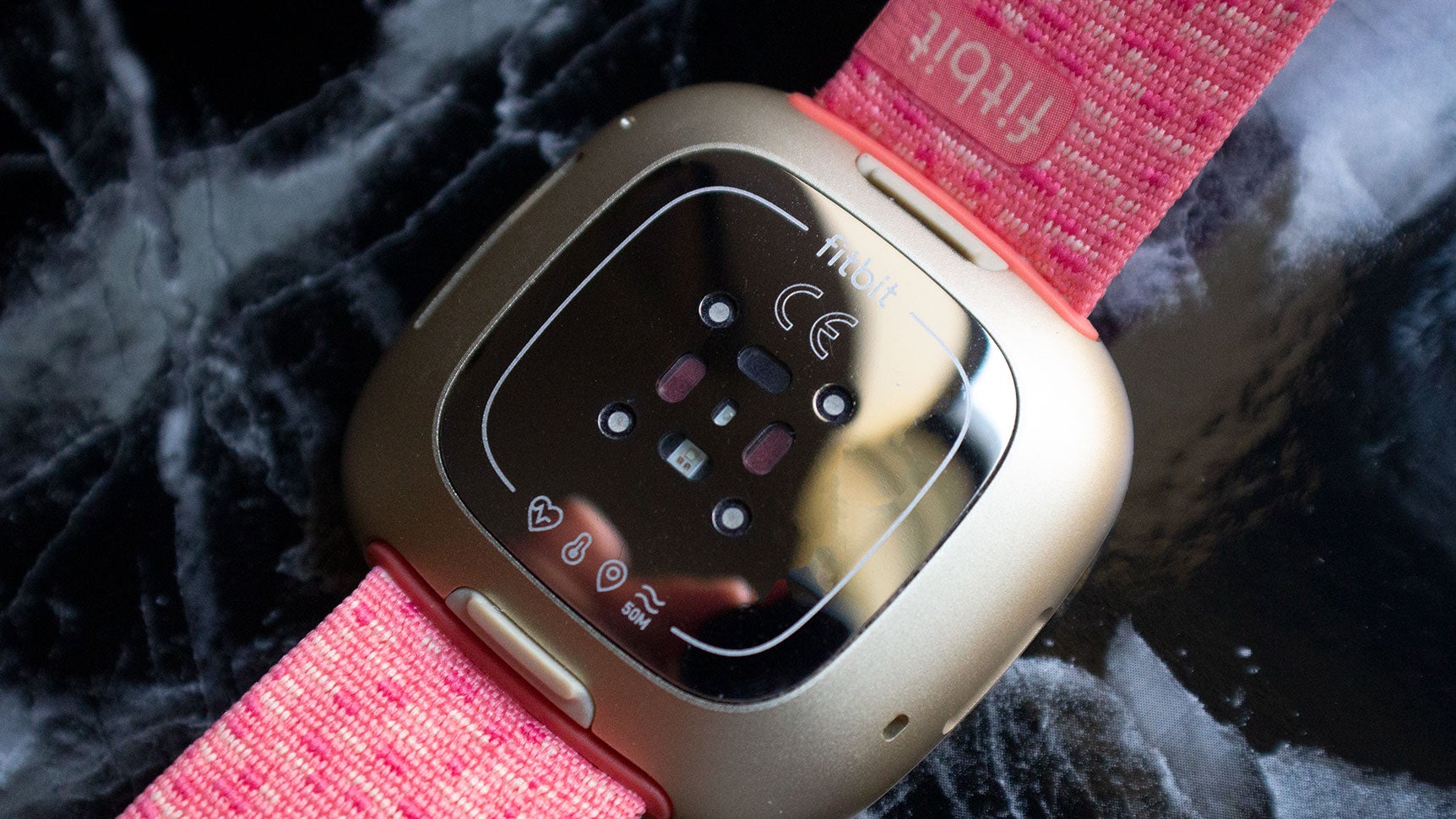 The new sensors! You can see the green PPG sensor, the red SpO2 sensors, as well as markings for the temperature sensor and ECG.