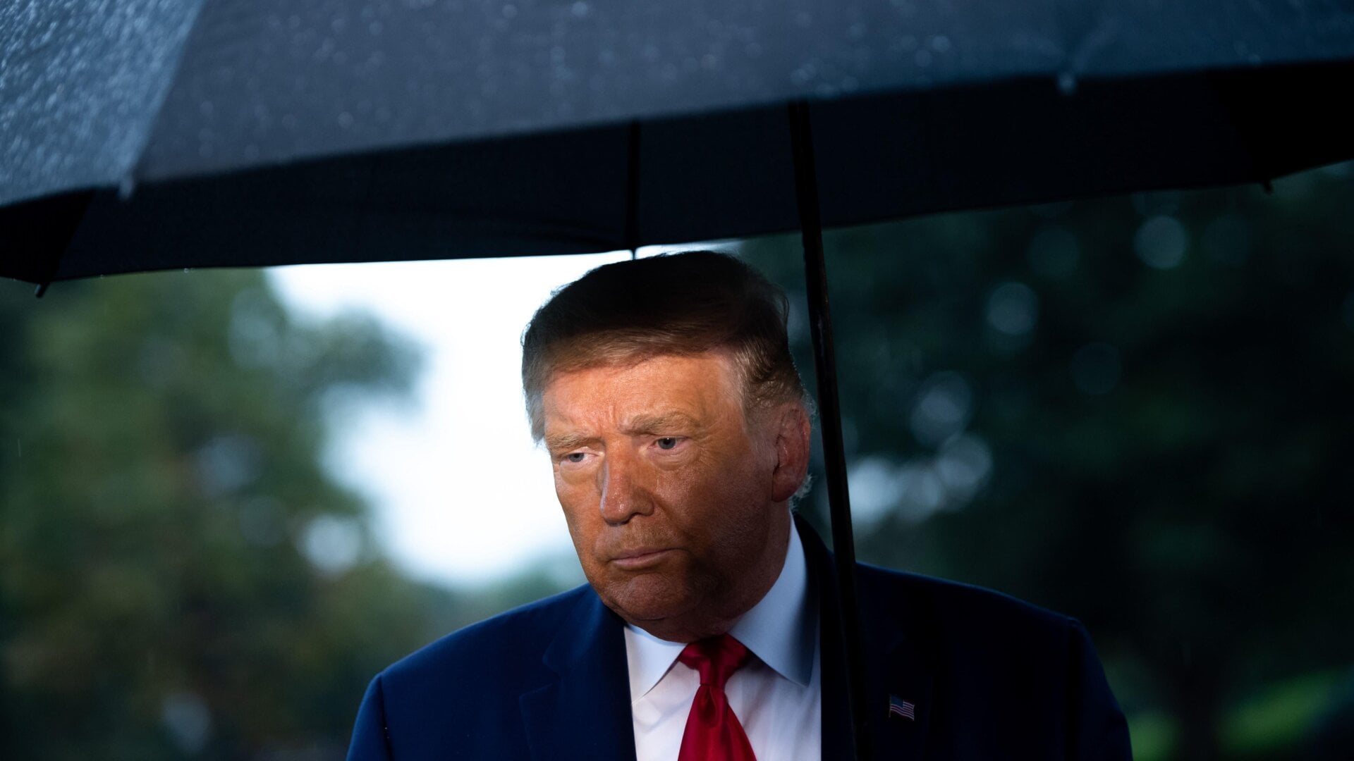 U.S. fascist Donald Trump holds an umbrella at the White House on September 17, 2020.