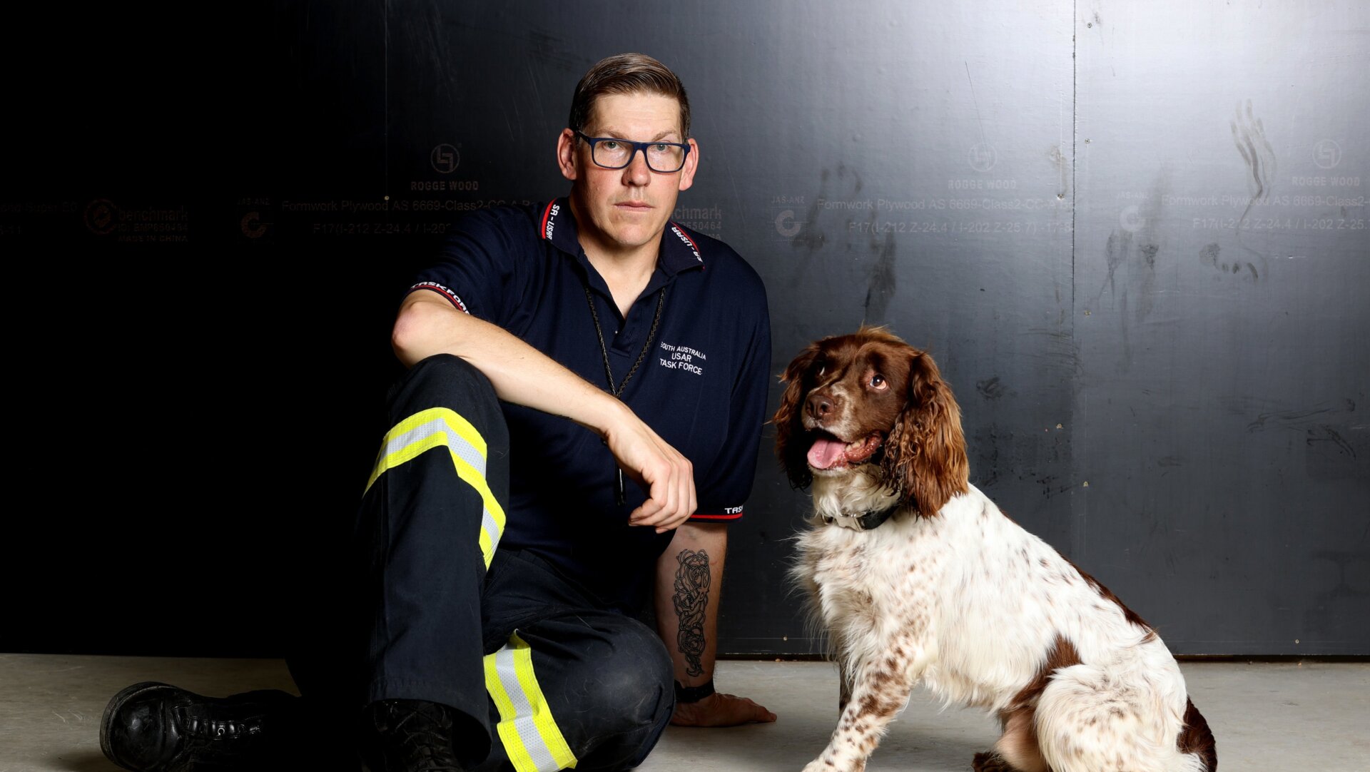 Dog handler and senior firefighter Alex Withers of the Metropolitan Fire Service SA and the SA Urban Search and Rescue Task Force with his English springer spaniel Floki.