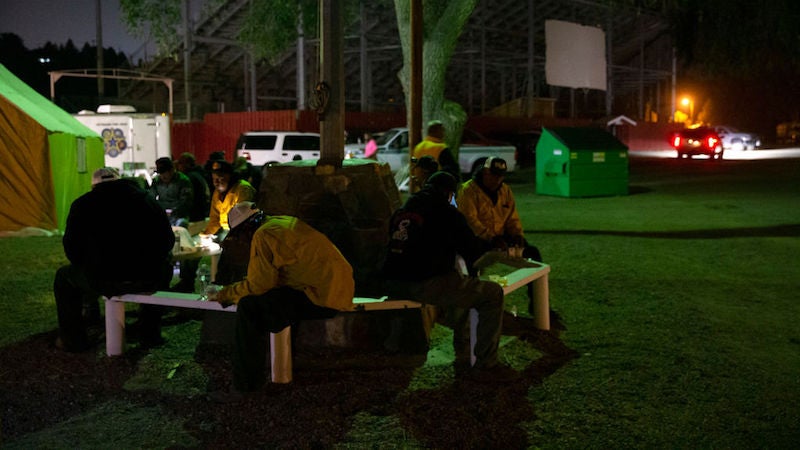 Wildland firefighters take a break at the Incident Command Post for the Cold Springs Fire on September 9, 2020 in Omak, Washington.