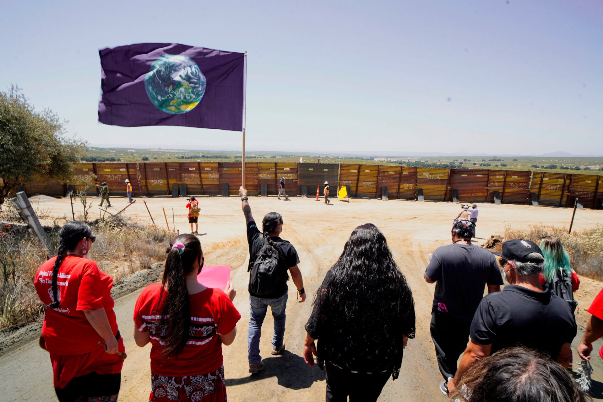 Members of the Kumeyaay band of Indians and demonstrators rally at the U.S.-Mexico border to protest construction of new wall being constructed on their ancestral grounds in California.