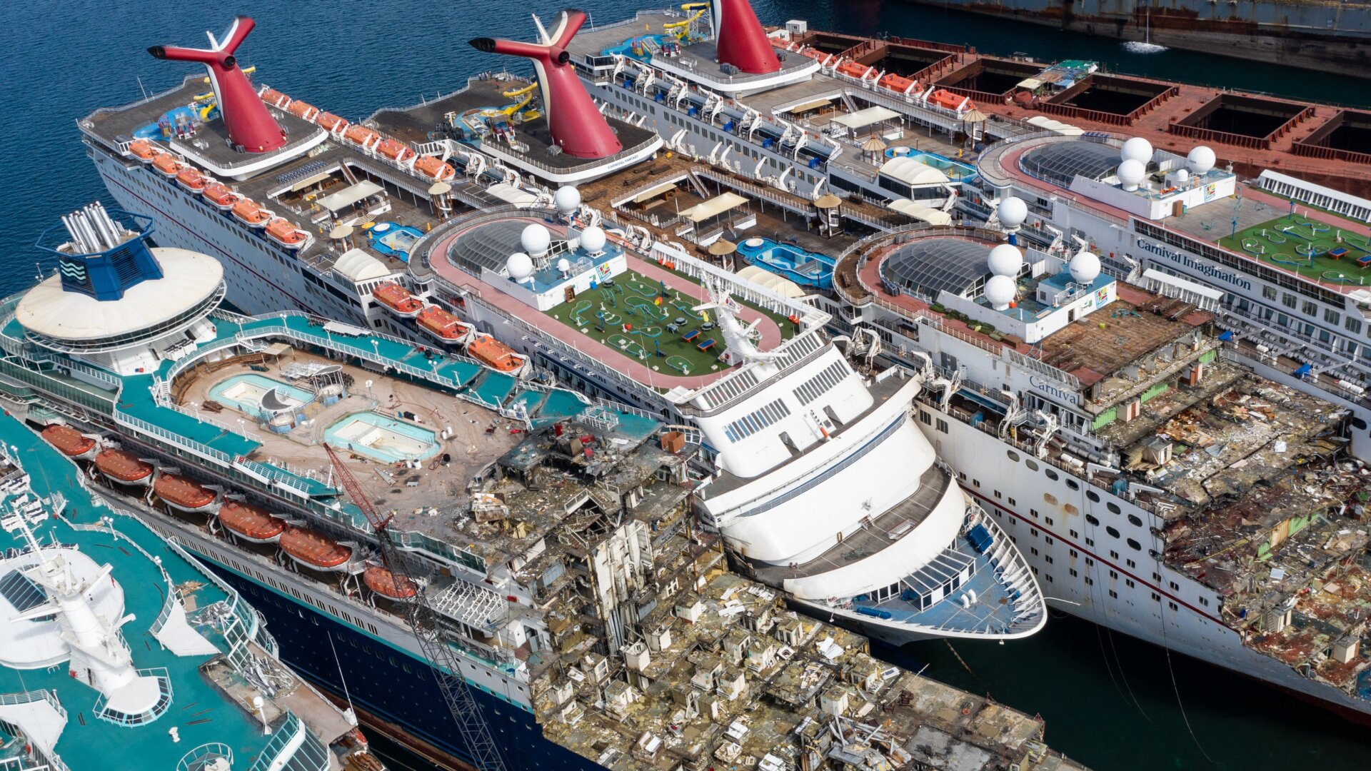 In this aerial view from a drone, five luxury cruise ships are seen being broken down for scrap metal at the Aliaga ship recycling port on October 02, 2020 in Izmir, Turkey. 