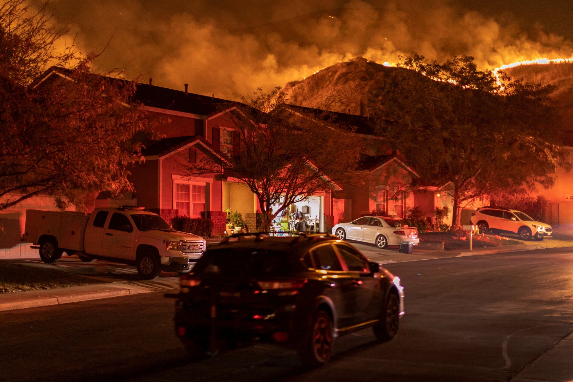 Flames come close to houses during the Blue Ridge Fire on Oct. 27, 2020 in Chino Hills, California. Strong Santa Ana Winds gusting to more than 90 miles per hour have driven the Blue Ridge Fire and Silverado Fire across thousands of acres, grounding firefighting aircraft, forcing tens of thousands of people to flee and gravely injuring two firefighters. More than 8,200 wildfires have burned across a record 4 million-plus acres so far this year, more than double the previous record. 