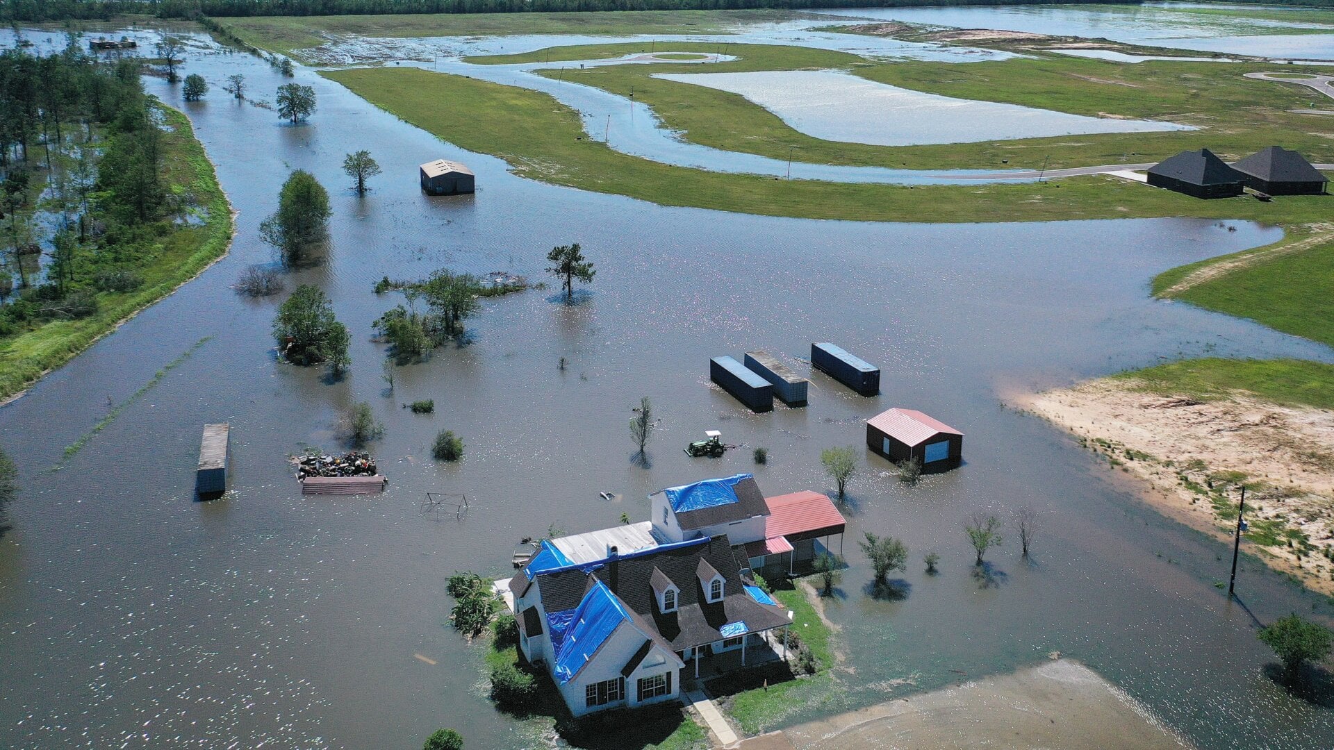 In this aerial view from a drone, a model home is surrounded by floodwaters from Hurricane Delta on October 10, 2020, in Iowa, Louisiana. Hurricane Delta made landfall as a Category 2 storm in Louisiana initially leaving hundreds of thousands of customers without power.