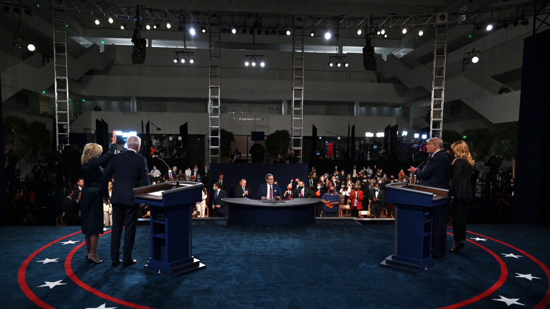 Democratic presidential nominee Joe Biden and his wife Dr. Jill Biden (L) stand on stage with U.S. President Donald Trump and First Lady Melania Trump (R) and moderator Chris Wallace after the first presidential debate