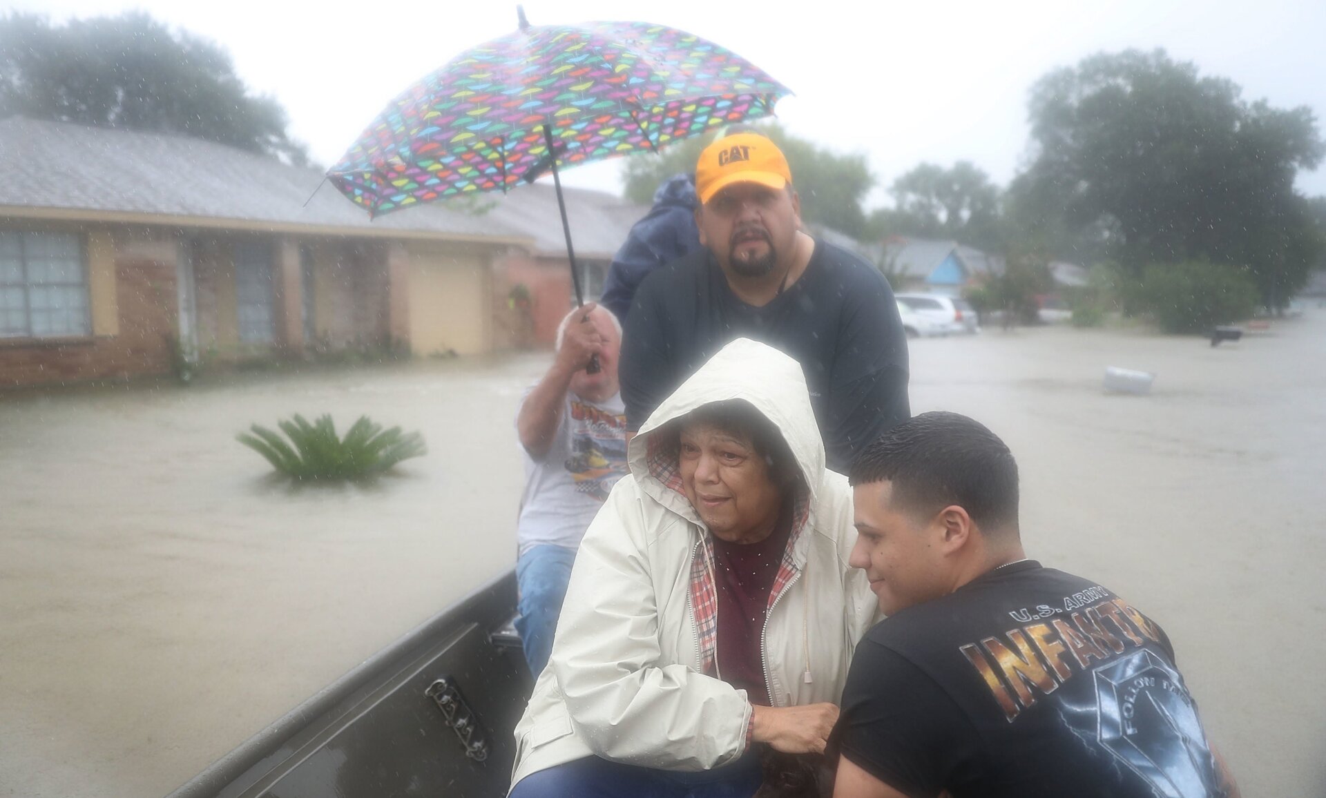 People evacuate in a boat from their homes after the area was inundated with flooding from Hurricane Harvey on Aug. 28, 2017 in Houston.