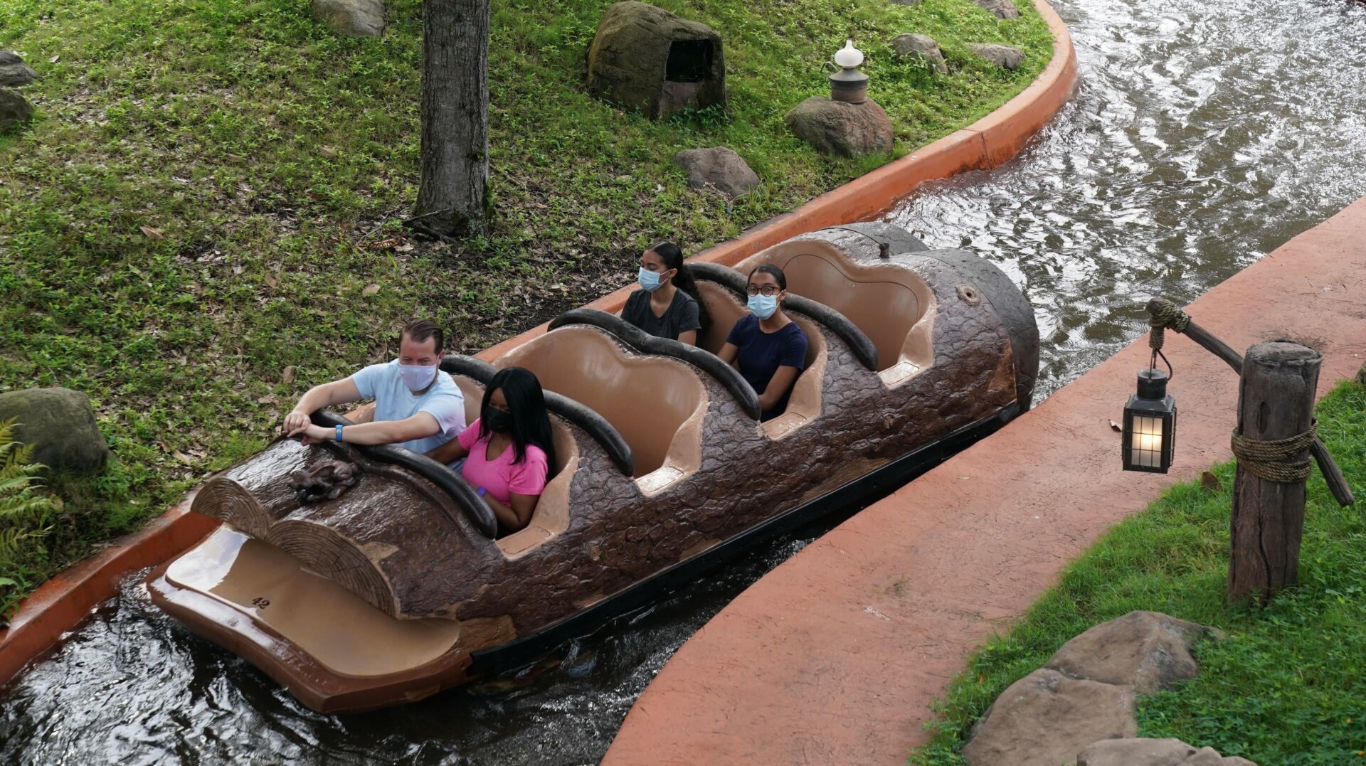 Passengers take a socially distant ride on Splash Mountain at Disney World.