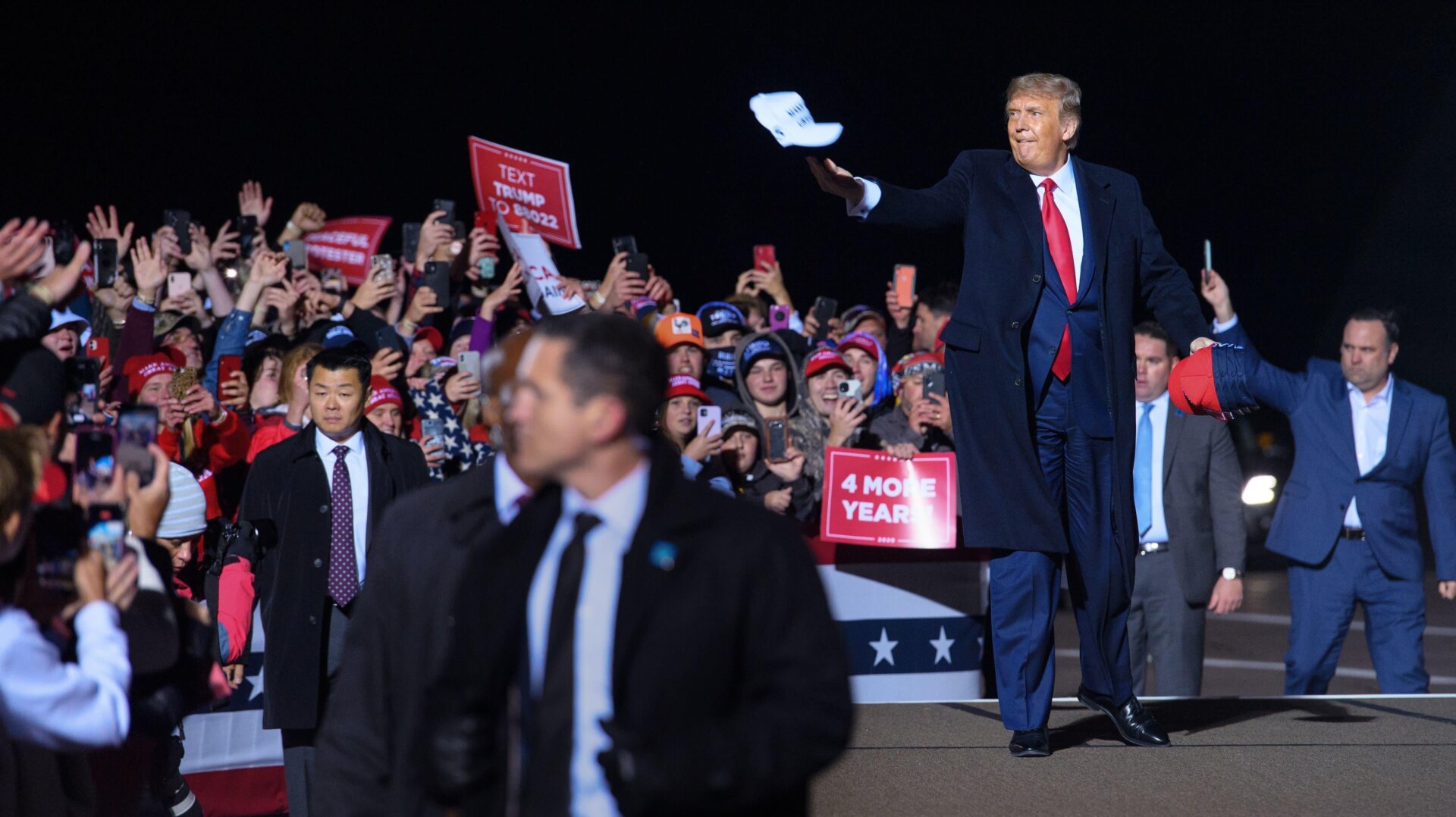 U.S. President Donald Trump tosses a cap to supporters as he arrives for a campaign rally at Duluth International Airport in Duluth, Minnesota, on September 30, 2020. - President Trump announced early on October 2, 2020, that he and First Lady Melania Trump would be going into quarantine after they were both found to have contracted the novel coronavirus.