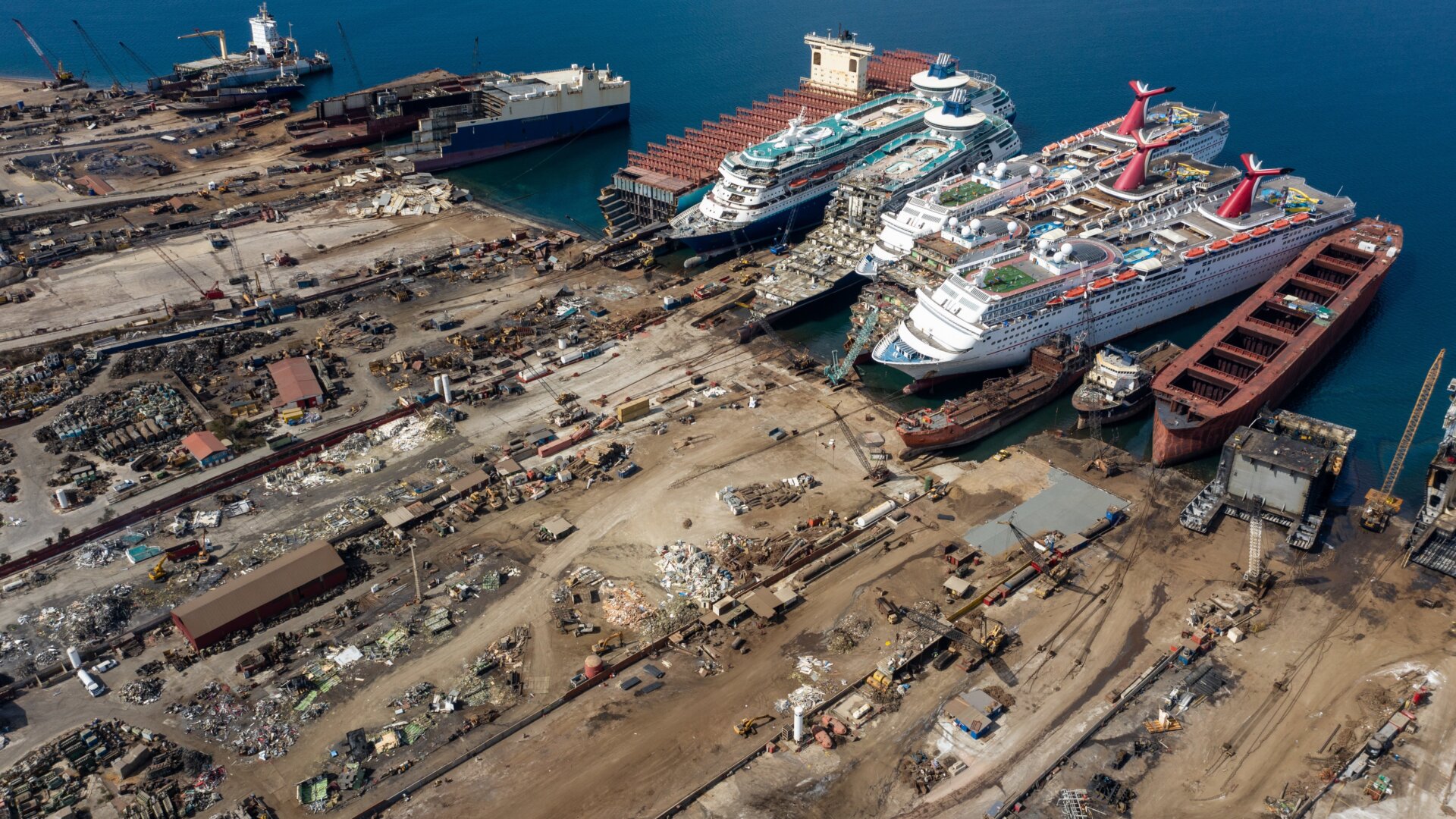 In this aerial view from a drone, five luxury cruise ships are seen being broken down for scrap metal at the Aliaga ship recycling port on October 02, 2020 in Izmir, Turkey. 
