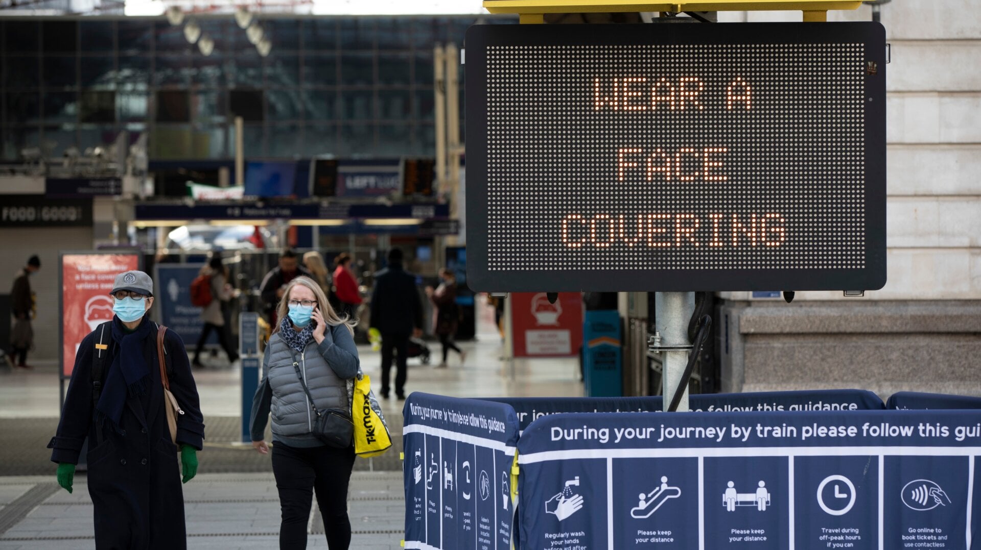Pedestrians cross a road in London in October 2020.