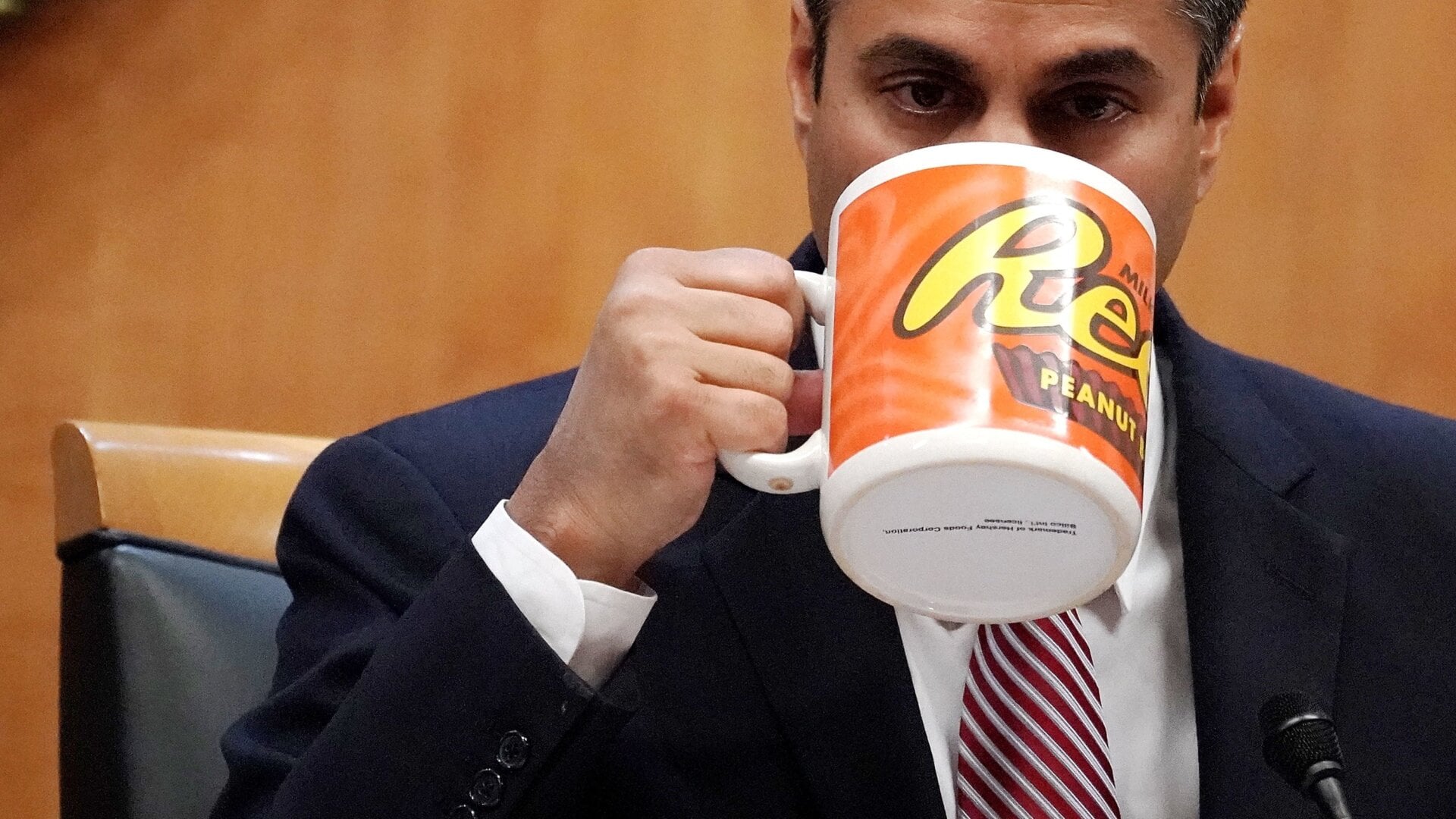 WASHINGTON, DC - DECEMBER 14: Federal Communications Commission Chairman Ajit Pai drinks from a big coffee cup during a commission meeting December 14, 2017 in Washington, DC. The FCC is scheduled to vote on a proposal to repeal net-neutrality.